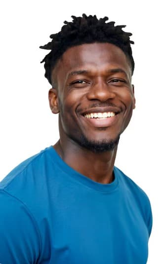 Smiling Black man with short dreadlocks wearing a blue t-shirt against a white background.